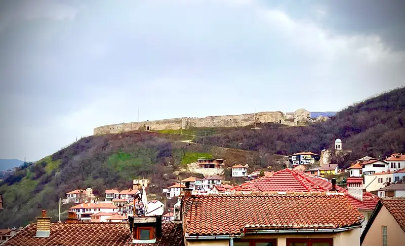 Prizren Fortress walls on the hill above the red roofs of the Old Town
